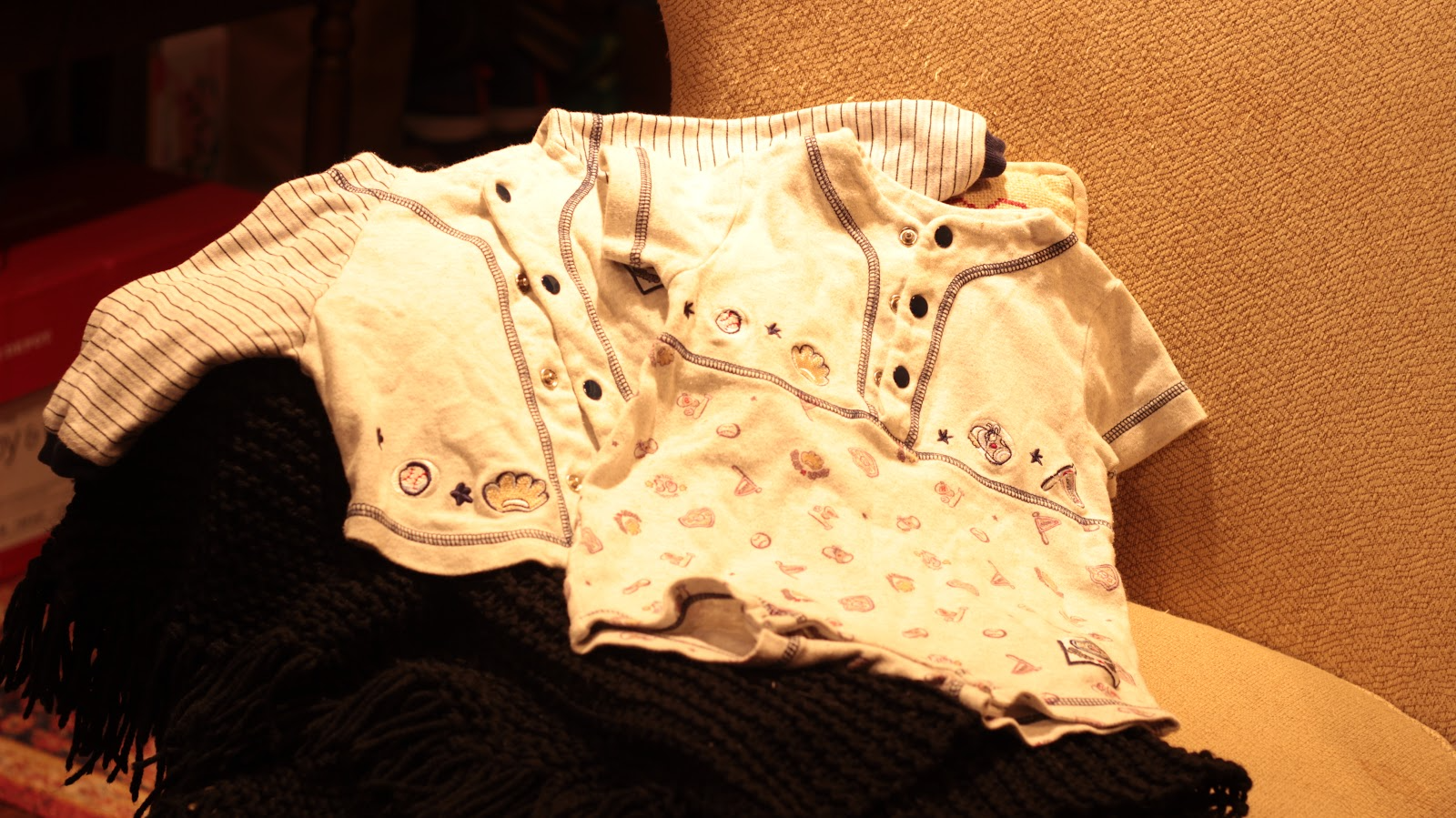 A set of PJs for a 9 month old, the fabric printed with baseballs.