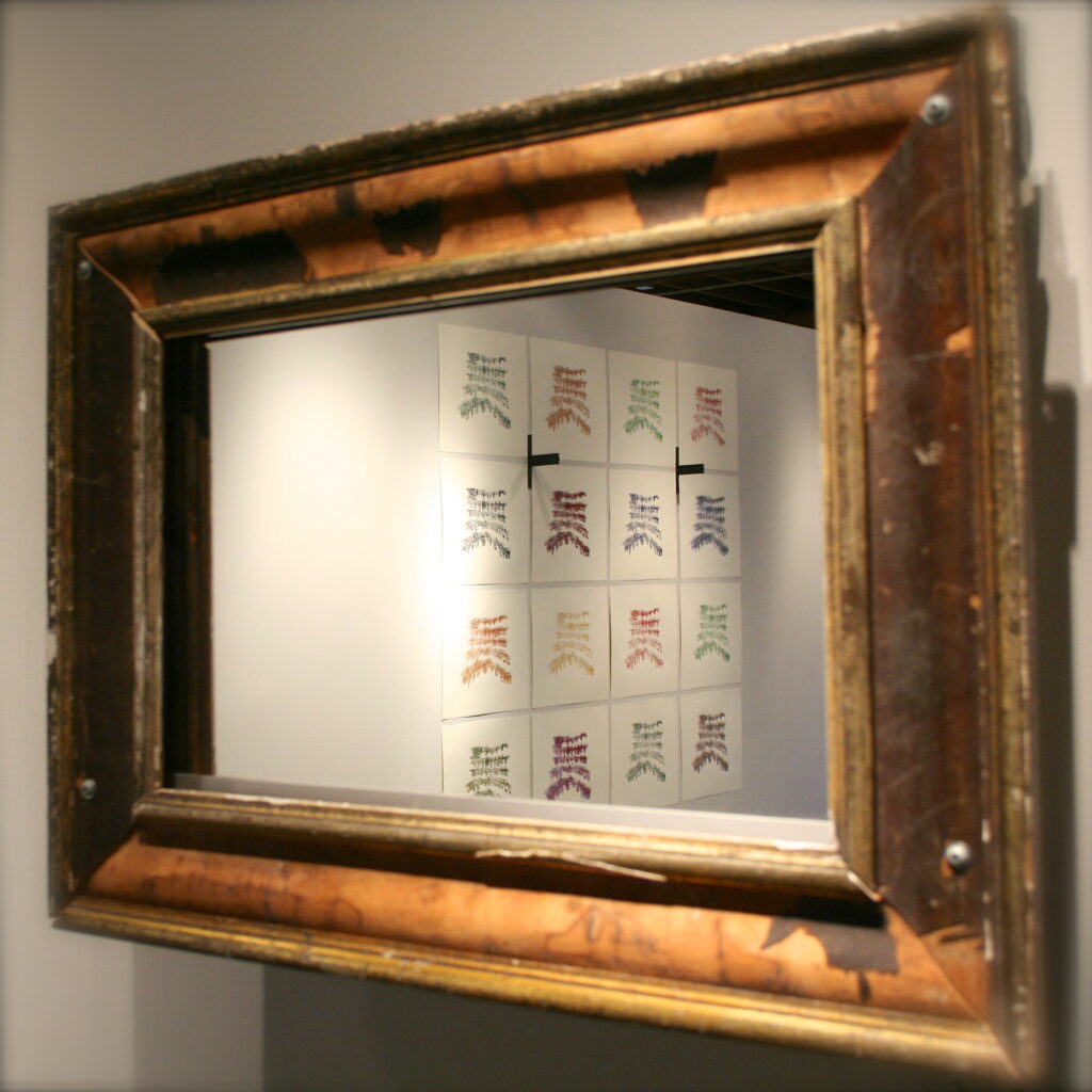 A piece from the Trimpin exhibit. The mirror slides back to reveal a Thomas Kincaide painting the artist received as a gift.
"Absit Invidia, no offense intended"